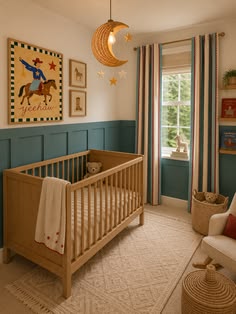 Cozy nursery with teal wainscoting, a natural wood crib, vintage storybook prints, and a paper moon lantern by the window